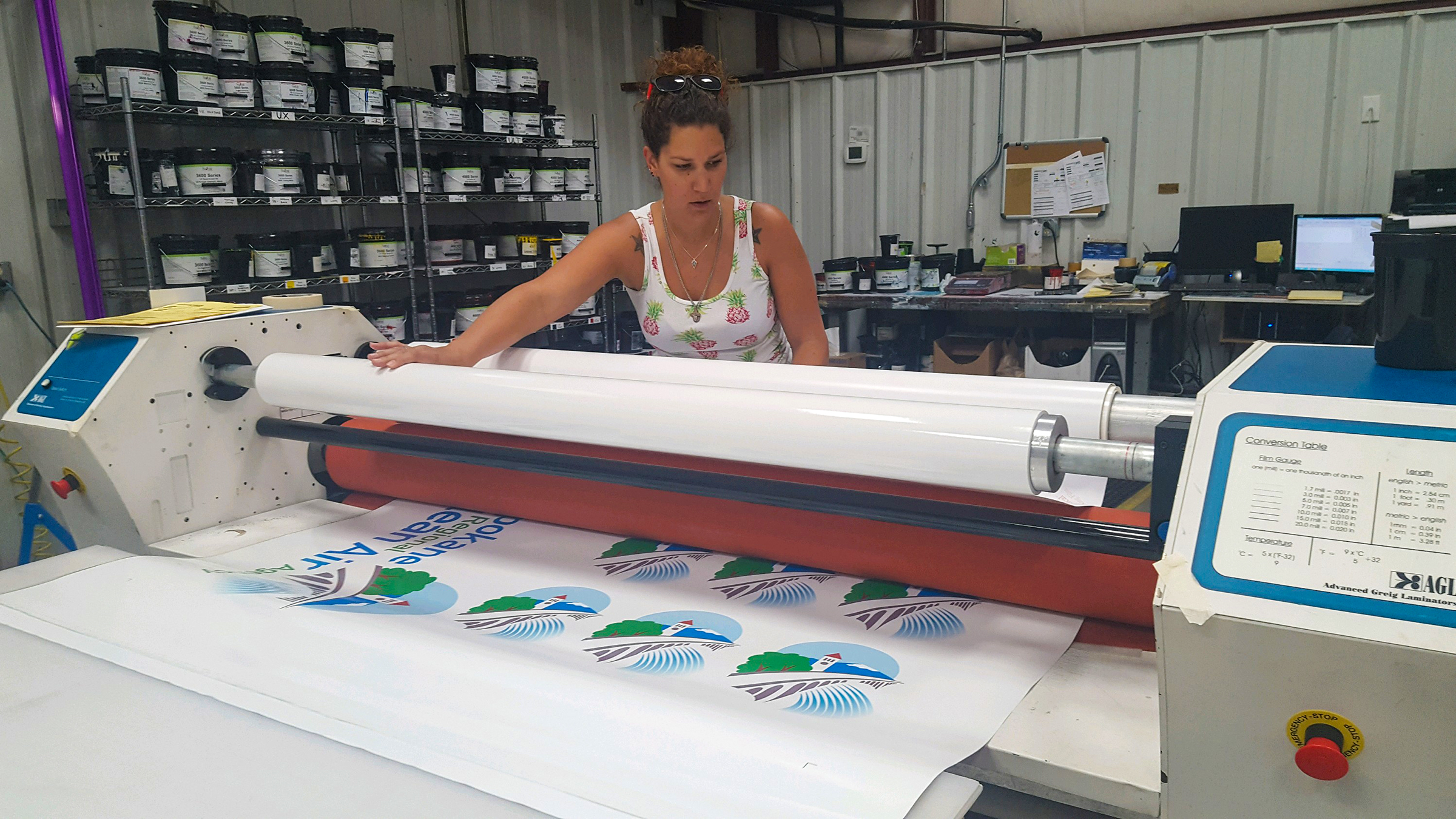 designer decal employee laminating a product